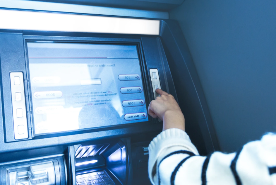 woman's hand pressing Atm button