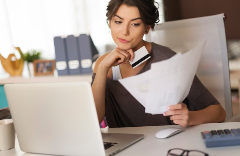 Pensive woman paying bills at home