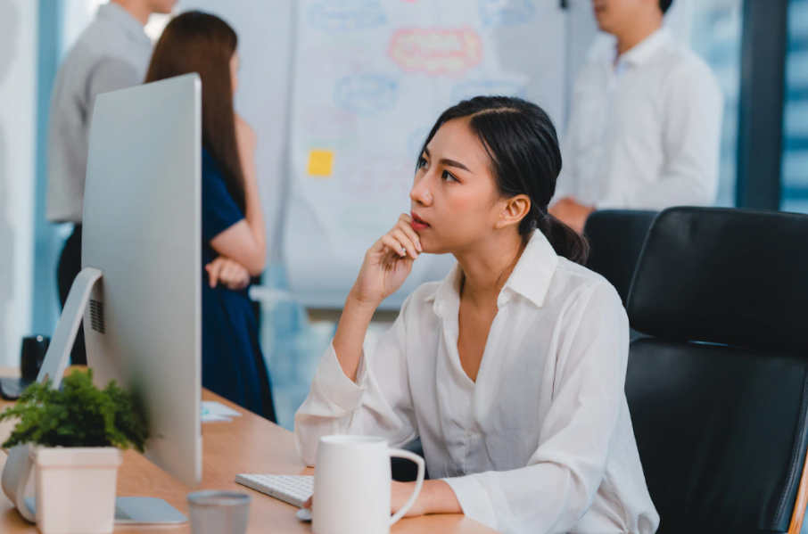 women sitting on her desk using her computer