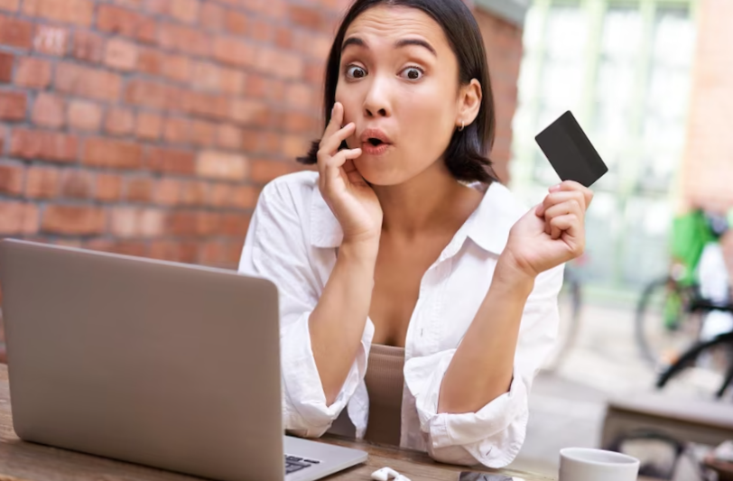 stylish young asian woman sitting with credit card and laptop