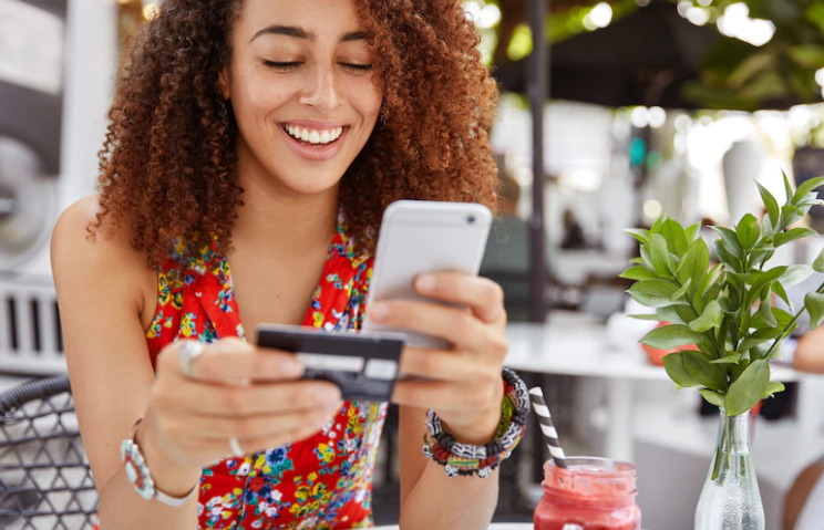 woman with a zero interest credit card on her hand