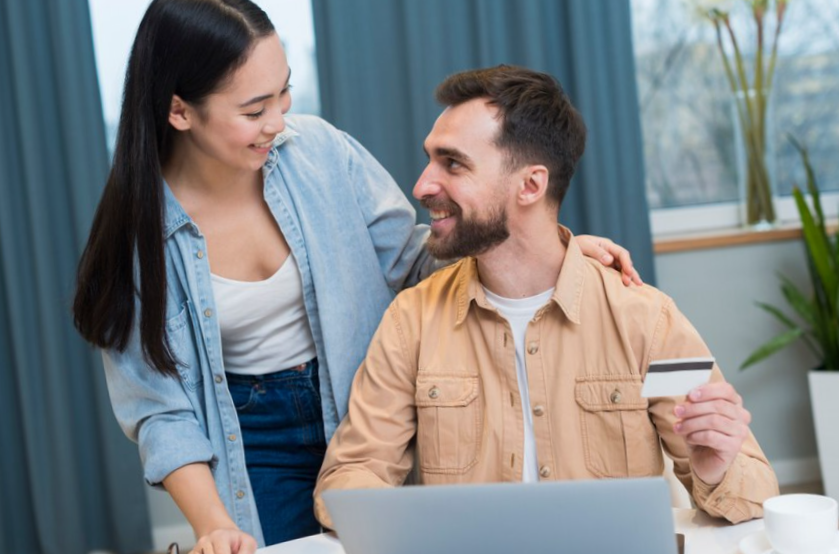 smiley couple enjoying a session of online shopping
