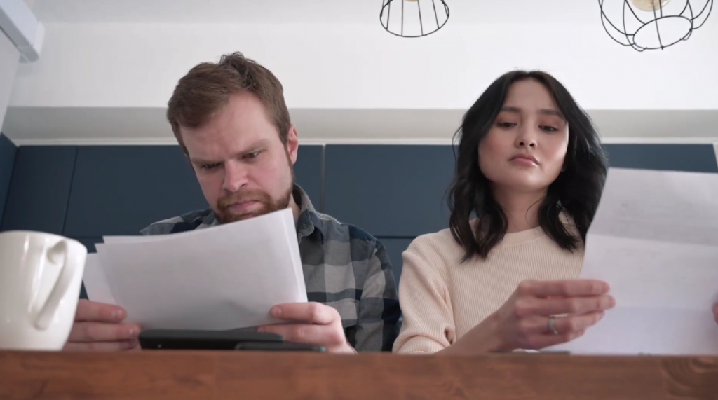 husband and wife reviewing documents for assistance
